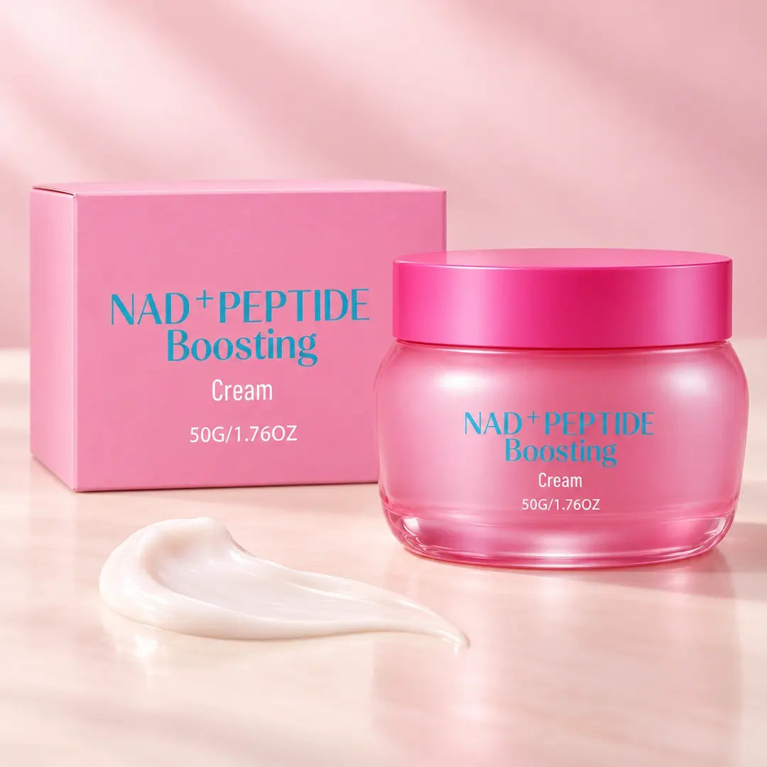 Pink NAD+ Peptide Boosting Cream jar with matching box and a white cream swatch on a blush-toned surface.